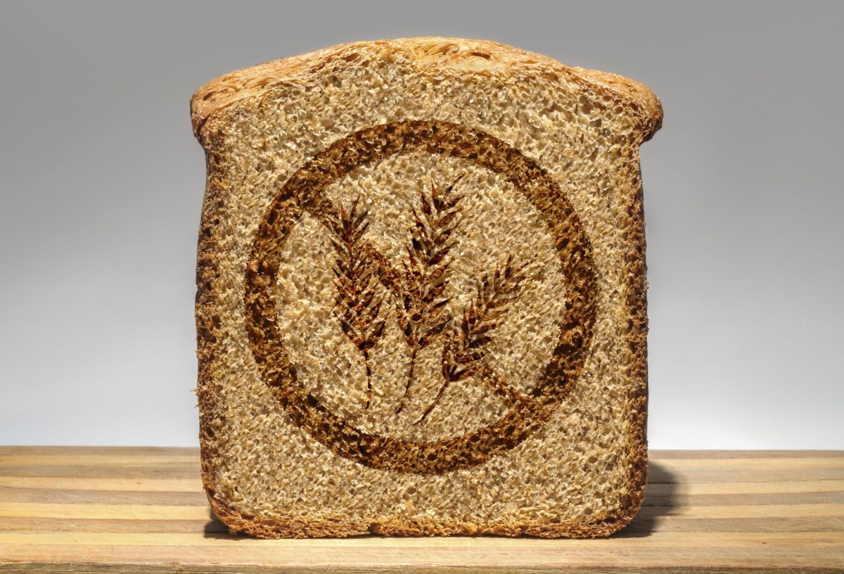 Slice of bread stamped with a gluten-free marking.