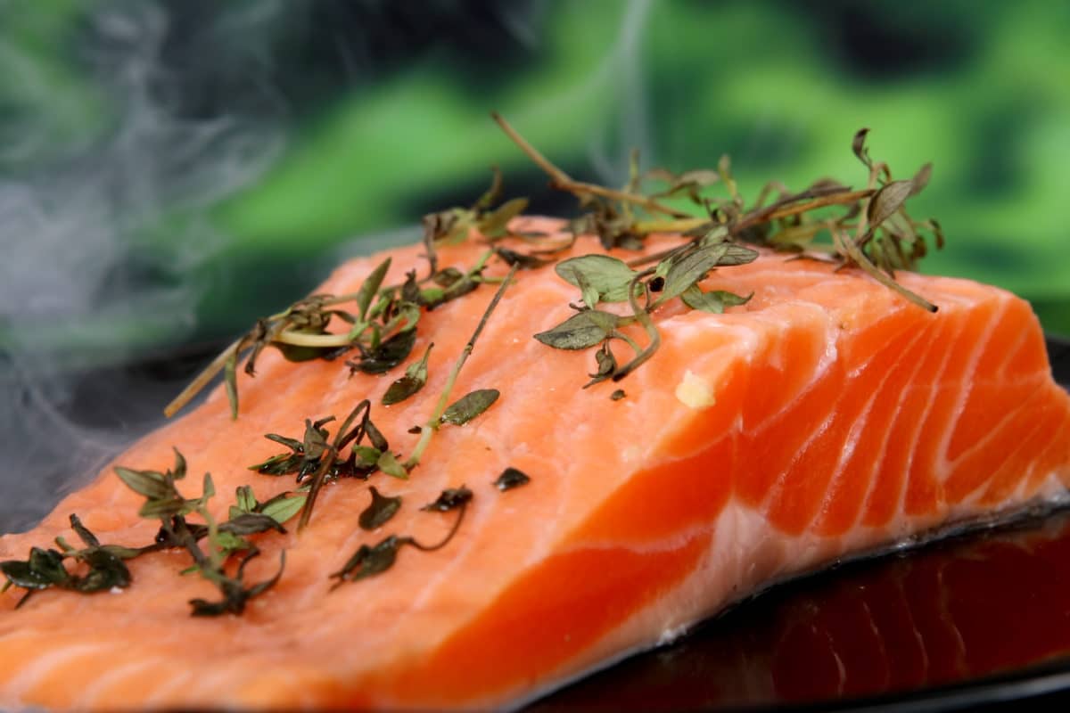 Fresh salmon fillet garnished with herbs